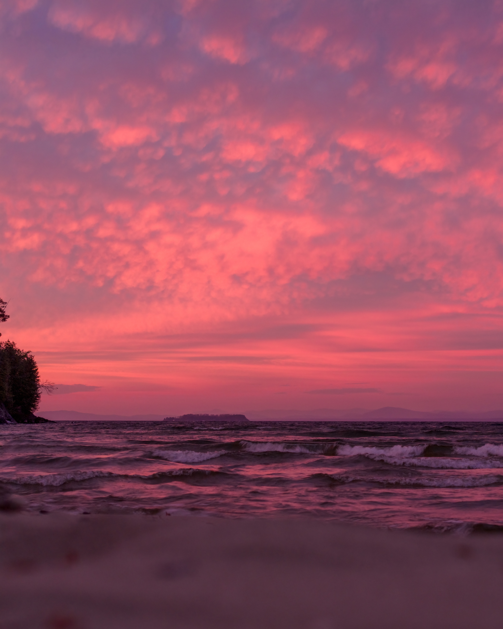 a vertical panorama of a shoreline and sunrise.